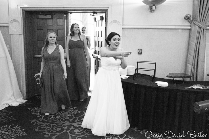 Brides reaction to the reception decorations at the wedding reception in the Grand Ballroom at the Inn at St. John's in Plymouth MI by Craig David Butler