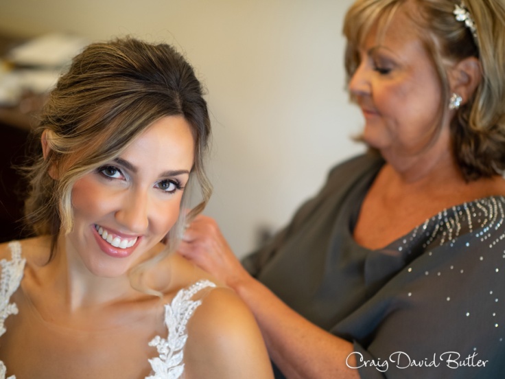 Bride getting in to her gown at Saint John's Resort in Plymouth